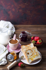Fresh and bright continental breakfast table with jam on toast