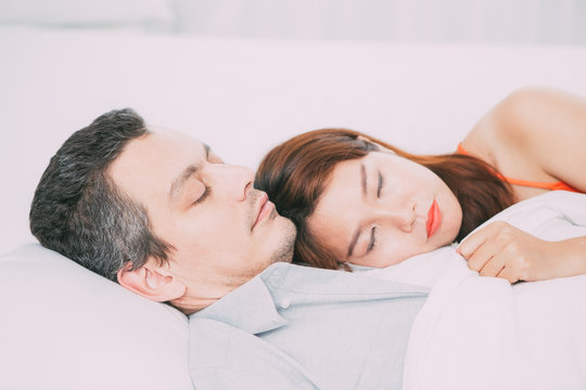 Affectionate Interracial Couple Sleeping in Bed - Powered by Adobe
