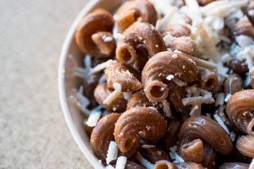 Cooked Whole Wheat Brown Pasta with cheese.