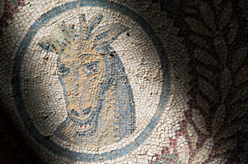 Fototapeta na wymiar Old roman mosaics in the famous imperial Villa del Casale in Piazza Armerina, Sicily, Unesco world heritage of the 4th century A.C.