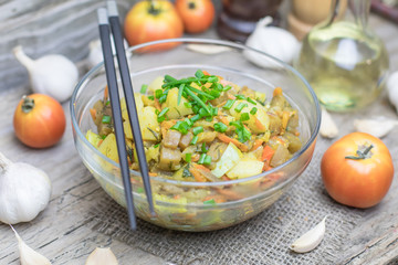 Homemade nutritional vegetable ragout in glass plate bowl on rustic old wooden table. Vegan or vegetarian food diet. Selective focus.