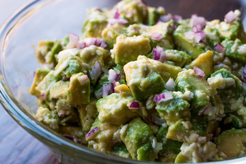 Avocado Salad with Red Onions in glass bowl.