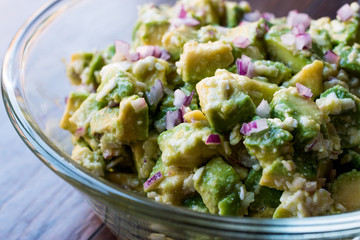 Avocado Salad with Red Onions in glass bowl.