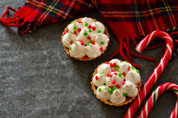 Holiday, Christmas tartlets with meringue and decorated with caramel almonds