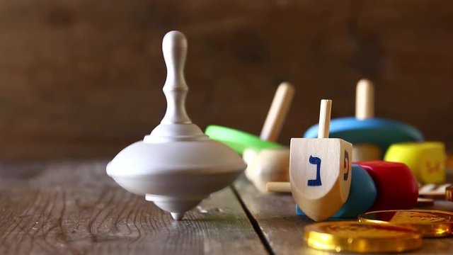 jewish holiday Hanukkah footage with traditional wooden spinnig dreidel (spinning top).