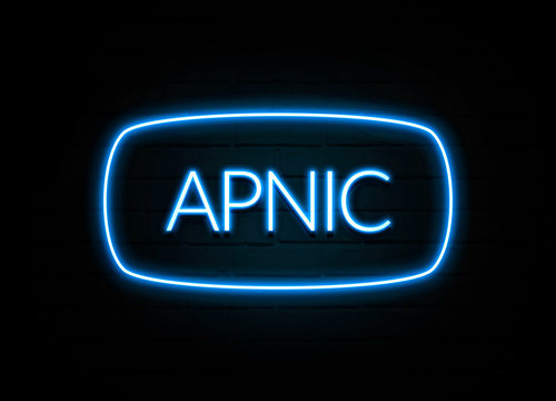 Apnic  - colorful Neon Sign on brickwall