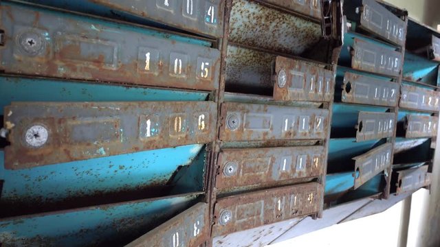 Chernobyl zone, Ukraine - 18th of June 2017: Visit to Pripyat Ghost Town - 4K Broken mail boxes at the entrance of one of Pripyat residential houses