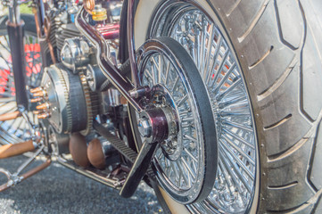 the rear wheel of a motorcycle with a belt transmitting rotation