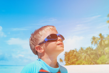 little boy play have fun on tropical beach