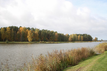 Countryside view of small river pond near small city in autumn, Latvia.