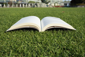 A book laid on grass