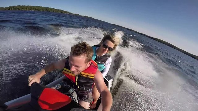 adventurous couple riding seadoo together selfie
