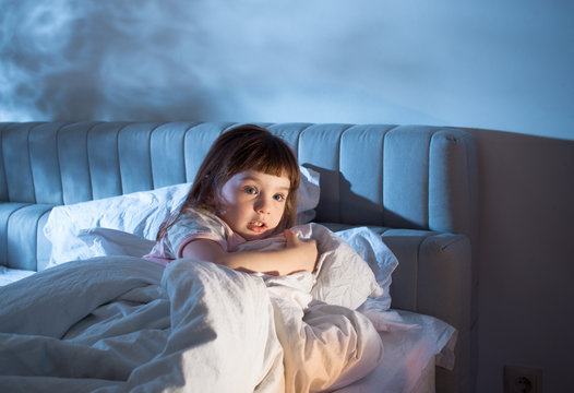 The girl feels the fear while lying in bed