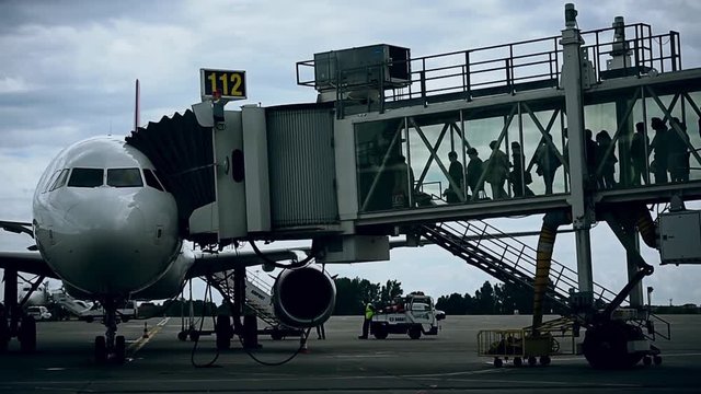 Passengers boarding on airplane through a jetway