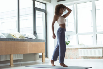 Beaming girl practicing sports in room