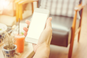 Close up of beautiful woman holding smartphone in restaurant with friend