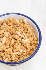 granola with nuts in the bowl on wooden background