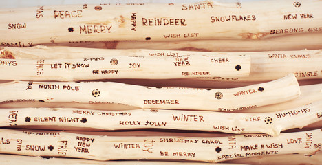 background of christmas greeting inscription burned on driftwood