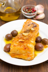 fried cod fish with garlic and olive oil on dish