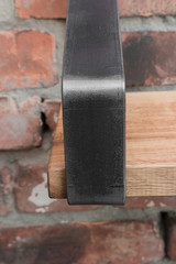 Shelf in wood and metal hanging on a brick wall in loft style