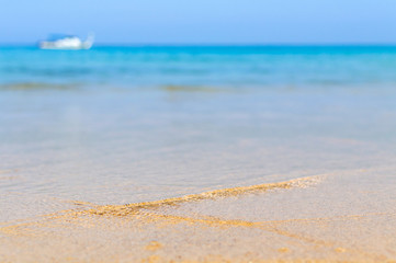 Soft Wave Of Blue Ocean On Sandy Beach. Background. Selective focus