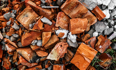 Construction garbage background. Pieces of broken bricks