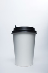 Mockup image of paper cup with cap on clean bacground