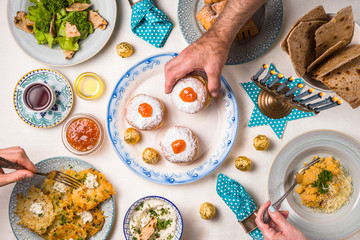 Jewish religious holiday Hanukkah, feast, hands over the table