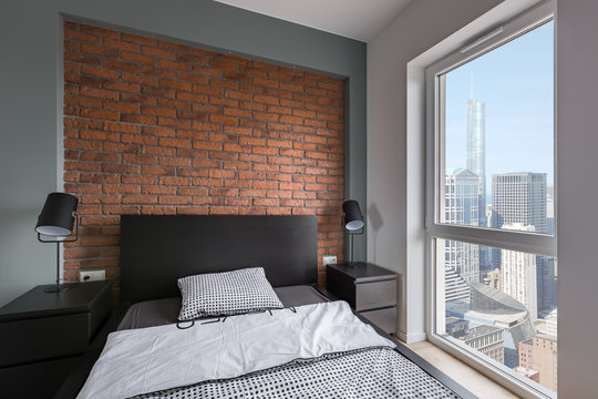 Industrial bedroom with brick wall