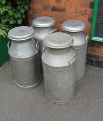 Four Vintage Metal Milk Churns Ready for Collection.