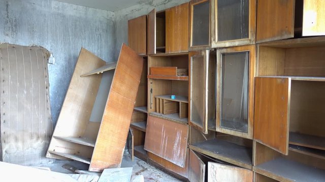 Chernobyl zone, Ukraine - 18th of June 2017: Visit to Pripyat Ghost Town - 4K Living room with broken furniture after pillage in one of Pripyat residential houses