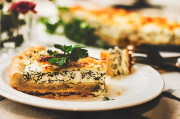 Sliced pie with spinach and cheese. Healthy homemade food photo concept