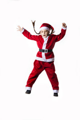 Fototapeta na wymiar Little caucasian girl dressed as Santa Claus jumping on white background.