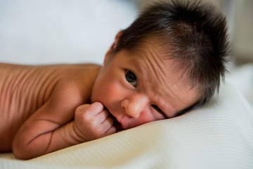 New born baby boy opens his eyes 