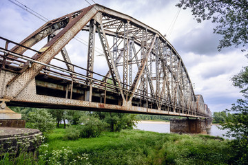 Rusty steel railroad bridge over Vistula River in Gora Kalawaria, Masovian Province of Poland