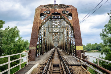 Rusty steel railroad bridge over Vistula River in Gora Kalawaria, Masovian Province of Poland
