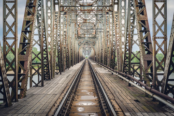 Fototapeta premium Rusty steel railroad bridge over Vistula River in Gora Kalawaria, Masovian Province of Poland