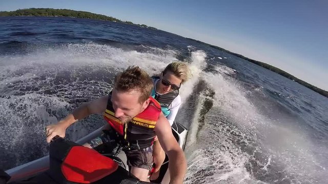 adventurous couple riding seadoo together slow motion