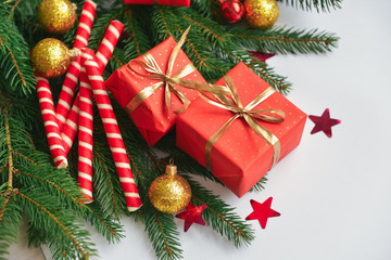 christmas composition, spruce branches to gifts in red boxes, christmas decor