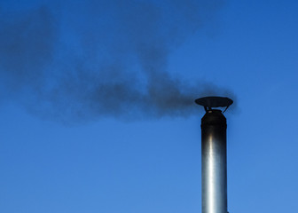 the smoke from the chimney against the sky.