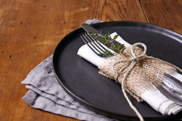 table setting fork and knife on plate with thyme
