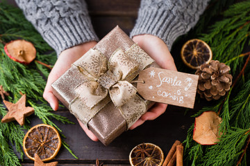 Woman hands making Christmas day gifts.