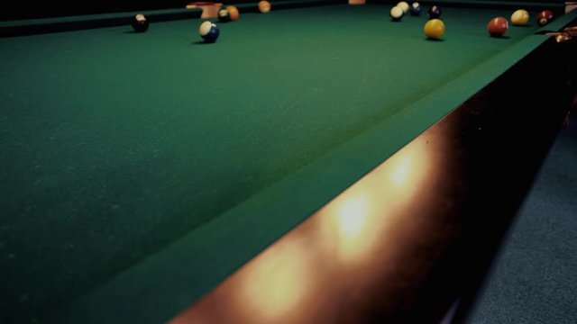 American billiard. Man playing billiard, snooker. Player preparing to shoot, hitting the cue ball.