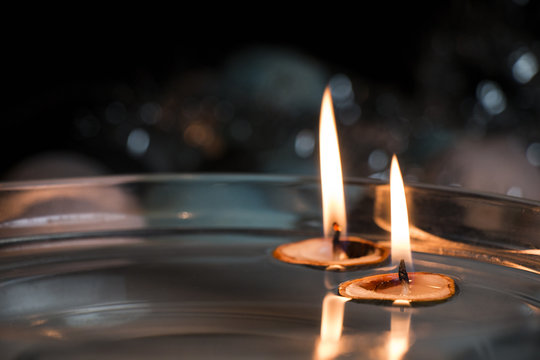 Close up of two floating candles in nut shells - christmas themed photo with selective focus