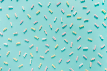 Fototapeta na wymiar Colorful marshmallow pattern on pastel blue background. Flat lay, top view.