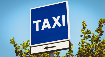 blue square sign indicating a taxi wire