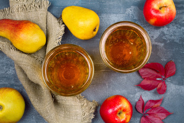 Cider with fruits. Glasses of cider with apples and pears. Food and drink concept. View from above, top studio shot, horizontal