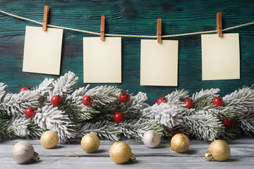 Four empty paper tags over wooden background with Xmas decoration