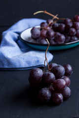 Black grapes on a black background