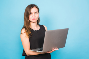 Naklejka premium business, technology and people concept - businesswoman with laptop on blue background